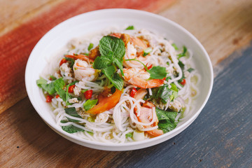 Spicy rice vermicelli with shrimp, minced pork and chili. Topping with mint leaves.