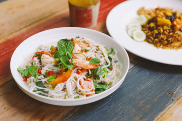 Spicy rice vermicelli with shrimp, minced pork and chili. Topping with mint leaves.