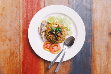Top view of Fried rice Mackerel Paste with Thai Mackerel and  that topping with Fried Chili. Served with Mackerel, Cucumber, Tomato and Lime.