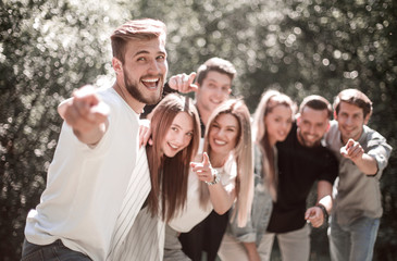 group a team of young people pointing at you