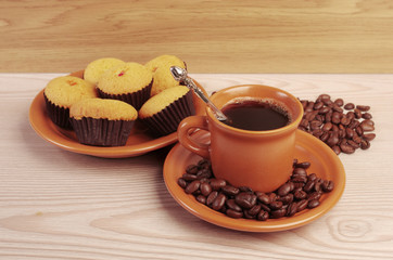 Cup of coffee, coffee beans and cupcakes