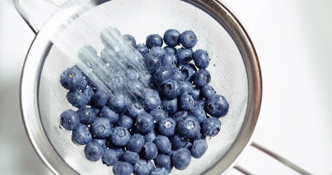 Fresh Picked Ripe Blueberries Washed in Colander Under Sink Water