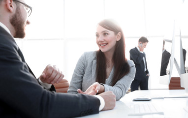 colleagues discussing information from the computer