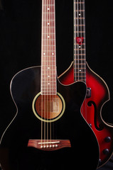 Obraz na płótnie Canvas Acoustic guitar and bass guitar on the dark