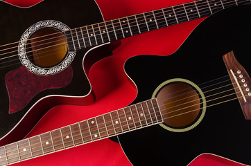 Fototapeta na wymiar Two acoustic guitars on red
