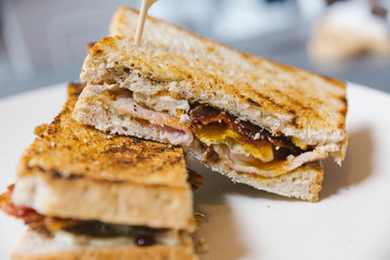 Close up Crispy Bacon stuffed French toast with fried egg.