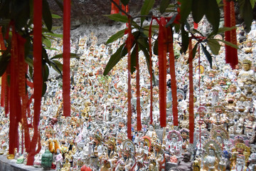 red ribbons on the branch near buddha temple