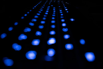 Computer keybord with bokeh blue lights in the dark