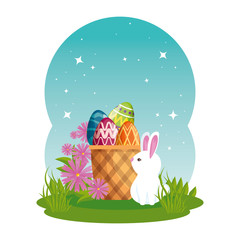 cute rabbit with easter eggs painted in basket and flowers
