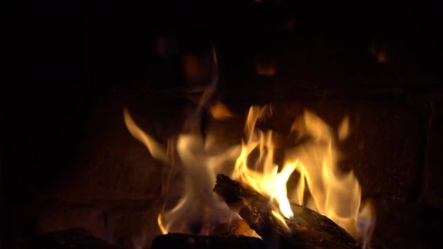 A fire burns in a brick fireplace, keep warm