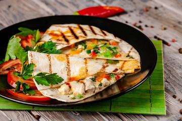 The concept of Mexican cuisine. Mexican tacos with chicken, corn, red beans, tomato, red onion and...