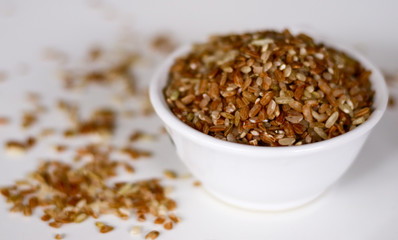 Brown rice on white background. 