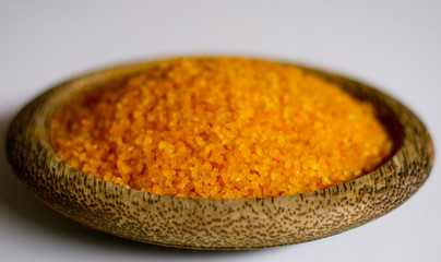 Yellow corn grits on white background. 