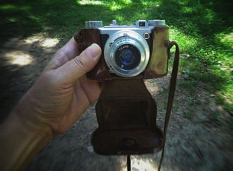 An old mechanical film camera  in your hand