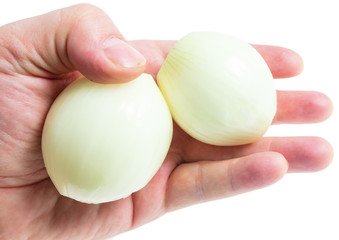 Peeled onions in hand on white background