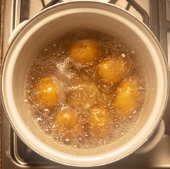 Potatoes are cooked in a pan in the kitchen