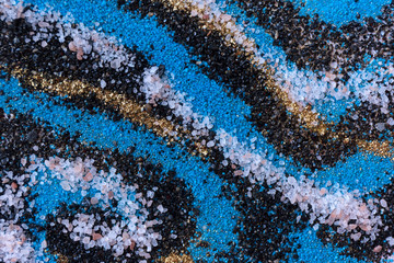 Layered colorful sand pattern. Marble style background. Blue and gold powder texture.