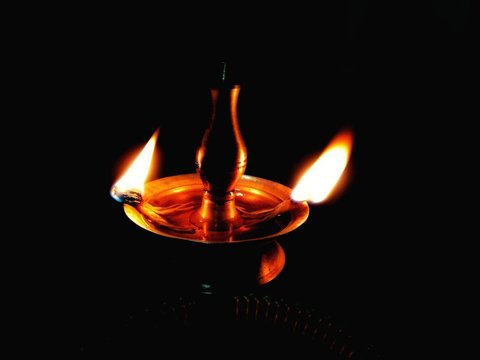 Puja Items: Oil Lamps and Black Wallpaper