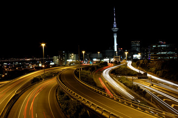 Auckland city and sky tower, skycity at night long exposure with car light trails on the highways.