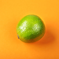 Fresh exotic lime on yellow background. Fruits background. Top view.