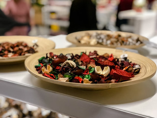 Dried flower petals many beautiful colors in white plate on plywood.