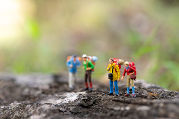 Miniature people : traveler walking on the roads are cluttered with grass. Used to travel to...