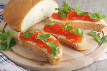 Sandwiches with butter and red caviar