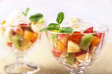 Diet-Fresh tasty mix fruit salad in the bowl on the wooden table, healthy breakfast, weight loss concept.