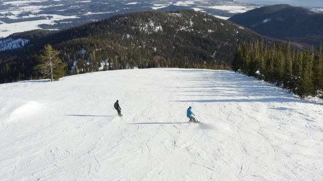 Two Snowboarding People Drone Aerial Follow Behind Amazing Birds Eye View Snowboard Extreme Winter Sport Downhill Ski Slope