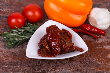 Dried tomatoes in the bowl with olive oil