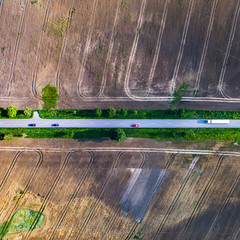 Aerial view of a country road between agricultural fields in Europe, Germany. Beautiful landscape. ...