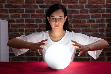 Woman Predicting Future With Crystal Ball