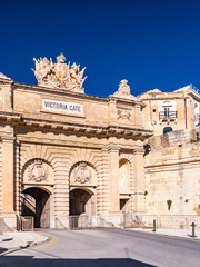 Fototapeta na wymiar Victoria Gate is a city gate in Valletta, Malta. The gate is the main entrance into the city from the Grand Harbour area, which was once the busiest part of the city.
