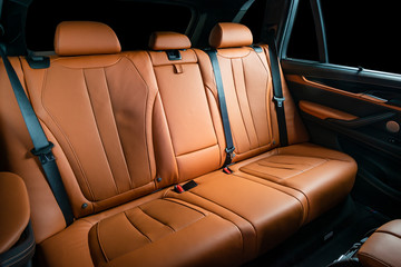 Red leather car seats, back passengers seats, modern comfortable cockpit