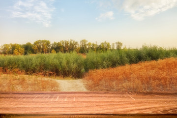 Empty wooden table with summer background of riverside at sunset for display or montage products