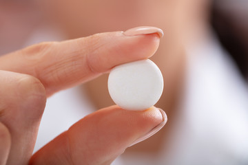 Female's Hand Showing White Tablet