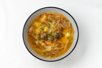 Russian cuisine. Meat soupe with vegetables - cabbage, carrot, potato. Top view