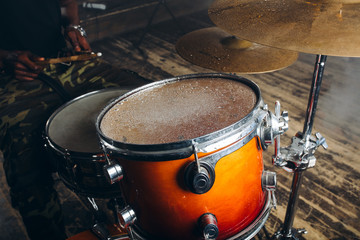 Fototapeta na wymiar close up photo of a rofessional drum set . live music concept.musical instrumnet after rain. raindrops on drum