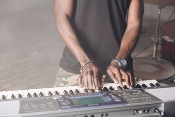 process of making music, sound. close up cropped photo. man's hands on keyboard . tool, instrumnet concept