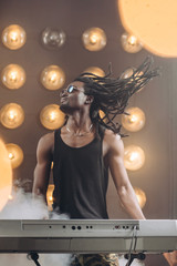 handsome afro guy playing music for a live audience. close up photo. euphoria concept