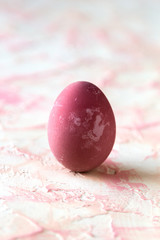 Pink easter egg on a pink background.