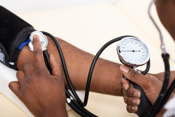 Doctor Measuring Blood Pressure Of Patient
