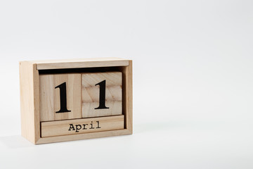 Wooden calendar April 11 on a white background