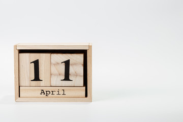Wooden calendar April 11 on a white background