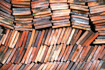 Obraz na płótnie Canvas Background of old clay tiles in a pile