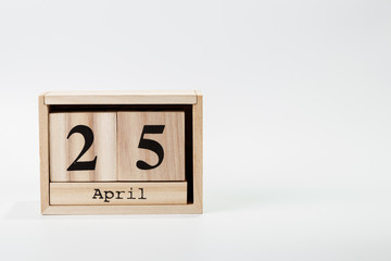 Wooden calendar April 25 on a white background