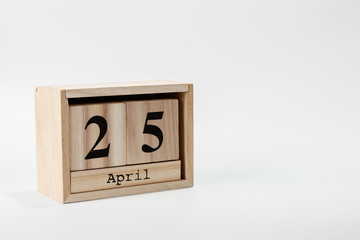 Wooden calendar April 25 on a white background