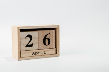 Wooden calendar April 26 on a white background