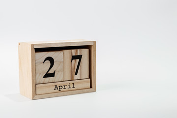 Wooden calendar April 27 on a white background