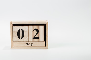 Wooden calendar May 02 on a white background
